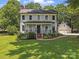 Charming two-story home features a welcoming front porch, complemented by a well-manicured lawn and lush landscaping at 18733 Bluff Point Rd, Cornelius, NC 28031