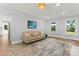 Inviting living room with ample natural light, a comfortable couch, and hardwood floors at 18733 Bluff Point Rd, Cornelius, NC 28031