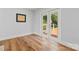Sunlit room featuring hardwood floors and french doors overlooking a beautiful backyard deck at 18733 Bluff Point Rd, Cornelius, NC 28031