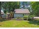 An outbuilding with an exterior staircase, greenhouse, and nicely landscaped mulch beds at 18733 Bluff Point Rd, Cornelius, NC 28031