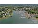 Stunning aerial view of waterfront homes, a large marina with boats, and lush green surroundings at 18853 Vineyard Point Ln, Cornelius, NC 28031