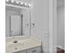Bathroom featuring a clean vanity with updated fixtures and vanity lighting at 18853 Vineyard Point Ln, Cornelius, NC 28031