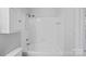 This simple bathroom has a shower with white tiles at 18853 Vineyard Point Ln, Cornelius, NC 28031