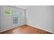 Bright bedroom features hardwood floors and multiple windows offering natural light at 18853 Vineyard Point Ln, Cornelius, NC 28031