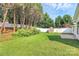 A long green lawn, a shed, and a white vinyl fence at 1922 Decatur Ct, Charlotte, NC 28213