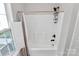 Bright bathroom features a shower with a curtain and a bronze shower head at 1922 Decatur Ct, Charlotte, NC 28213
