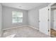 Bright, carpeted bedroom with a large window and neutral walls providing a calming atmosphere at 1922 Decatur Ct, Charlotte, NC 28213
