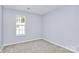 Neutral bedroom with soft carpet and a large window at 1922 Decatur Ct, Charlotte, NC 28213