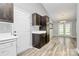 Open-concept eat-in dining room, adjacent to kitchen with dark cabinets, LVP floors, and sliding glass doors at 1922 Decatur Ct, Charlotte, NC 28213
