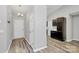 Bright entryway with new gray wood flooring, modern lighting fixture, and neutral wall paint at 1922 Decatur Ct, Charlotte, NC 28213
