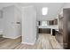 The kitchen features dark wood cabinetry, white countertops, stainless steel appliances, and wood-look laminate flooring at 1922 Decatur Ct, Charlotte, NC 28213