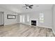 Bright living room with a fireplace, and adjacent dining area with access to the backyard at 1922 Decatur Ct, Charlotte, NC 28213