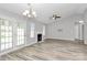 Bright living room boasts vaulted ceiling, fireplace, ceiling fan, and sliding glass doors to the backyard at 1922 Decatur Ct, Charlotte, NC 28213