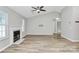 The spacious living room features a vaulted ceiling, fireplace, neutral paint, and wood-look laminate flooring at 1922 Decatur Ct, Charlotte, NC 28213