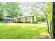 Well-maintained backyard featuring a deck and mature trees, providing a peaceful outdoor retreat at 214 Cottage Pl, York, SC 29745