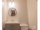 Bathroom featuring a vanity with gray cabinets and a round mirror at 214 Cottage Pl, York, SC 29745