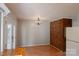 Traditional dining room with hardwood floors, brick accent wall and chandelier lighting at 214 Cottage Pl, York, SC 29745