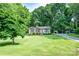 Charming single-story home with a brick facade, a well-manicured lawn, and mature trees at 214 Cottage Pl, York, SC 29745
