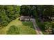 Charming single-story home with a brick facade, long driveway, and large lawn at 214 Cottage Pl, York, SC 29745