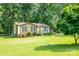 A cozy brick home with a tidy front yard and mature landscaping, creating a welcoming curb appeal at 214 Cottage Pl, York, SC 29745