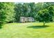 A charming single-story home with a well-manicured lawn and mature trees providing ample shade at 214 Cottage Pl, York, SC 29745