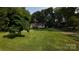 Well-maintained lawn and cozy home with a long driveway in a wooded area at 214 Cottage Pl, York, SC 29745