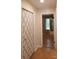 Hallway leading to a bedroom with wood flooring and decorative closet doors at 214 Cottage Pl, York, SC 29745
