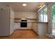Cozy kitchen with bright cabinets, wood countertops, white appliances, and backyard access at 214 Cottage Pl, York, SC 29745