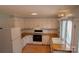 Charming kitchen with white cabinetry, butcher block countertops and modern appliances at 214 Cottage Pl, York, SC 29745