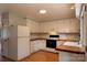 Spacious kitchen featuring white cabinetry, wood countertops, and modern appliances at 214 Cottage Pl, York, SC 29745