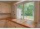 Bright kitchen sink with a large window overlooking the well-maintained backyard at 214 Cottage Pl, York, SC 29745