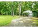 A versatile storage shed nestled among mature trees, providing ample space for tools and equipment at 214 Cottage Pl, York, SC 29745