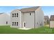 Exterior of the home showing the backyard with a gray siding and green grass at 219 Redondo Dr # 65, Wingate, NC 28174