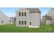 Exterior view of the home's backyard and back entrance surrounded by green grass at 219 Redondo Dr # 65, Wingate, NC 28174