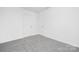 Bright bedroom with soft carpet, white walls, and two white doors at 219 Redondo Dr # 65, Wingate, NC 28174