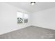 A bright bedroom with soft carpet and a large window offering neighborhood views at 219 Redondo Dr # 65, Wingate, NC 28174