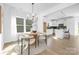 Bright dining area with a stylish chandelier and a round table, adjacent to the modern kitchen at 219 Redondo Dr # 65, Wingate, NC 28174