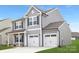 Newly constructed home boasting a two-car garage, gray siding, and a well-maintained front yard at 219 Redondo Dr # 65, Wingate, NC 28174
