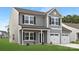 Beautiful two-story home with gray siding, white trim, a two-car garage, and a well-manicured lawn at 219 Redondo Dr # 65, Wingate, NC 28174
