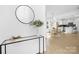 Inviting foyer with a modern console table, stylish mirror, and seamless transition to the dining and kitchen area at 219 Redondo Dr # 65, Wingate, NC 28174