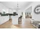 Bright open-concept kitchen with white cabinets, a center island, stainless steel appliances, and wood flooring at 219 Redondo Dr # 65, Wingate, NC 28174