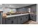 Stylish basement bar featuring granite countertops, gray cabinets, and a convenient sink at 2341 Shiny Leaf Dr, Denver, NC 28037