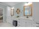 Bathroom featuring double sink vanity, quartz countertops, modern fixtures, and decorative clock at 2341 Shiny Leaf Dr, Denver, NC 28037