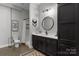 Stylish bathroom with modern vanity, decorative mirror, and a shower, designed for relaxation at 2341 Shiny Leaf Dr, Denver, NC 28037