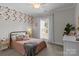 Charming bedroom with stylish wallpaper, natural light, and cozy furnishings at 2341 Shiny Leaf Dr, Denver, NC 28037
