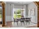 Bright dining room with wainscotting, chandelier, and a large window with backyard views at 2341 Shiny Leaf Dr, Denver, NC 28037