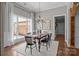Formal dining room with wood floors, white wainscotting and an elegant chandelier at 2341 Shiny Leaf Dr, Denver, NC 28037
