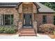 Inviting home entrance with brick steps, stone accents, and a stylish front door with sidelights at 2341 Shiny Leaf Dr, Denver, NC 28037