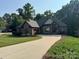 Charming brick home with manicured lawn and inviting driveway at 2341 Shiny Leaf Dr, Denver, NC 28037