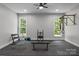 Home gym featuring weightlifting equipment, a bench, and plenty of natural light from two windows at 2341 Shiny Leaf Dr, Denver, NC 28037